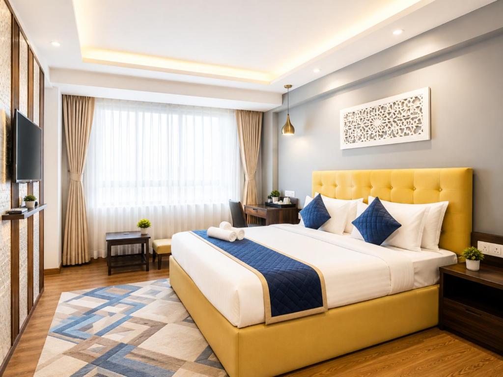 a hotel room with a bed and a television at Hotel Durga Palace in Sonepur