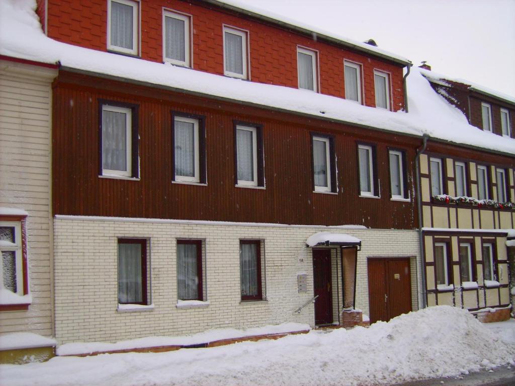 a large brick building with snow in front of it at Ferienhaus Benneckenstein in Benneckenstein