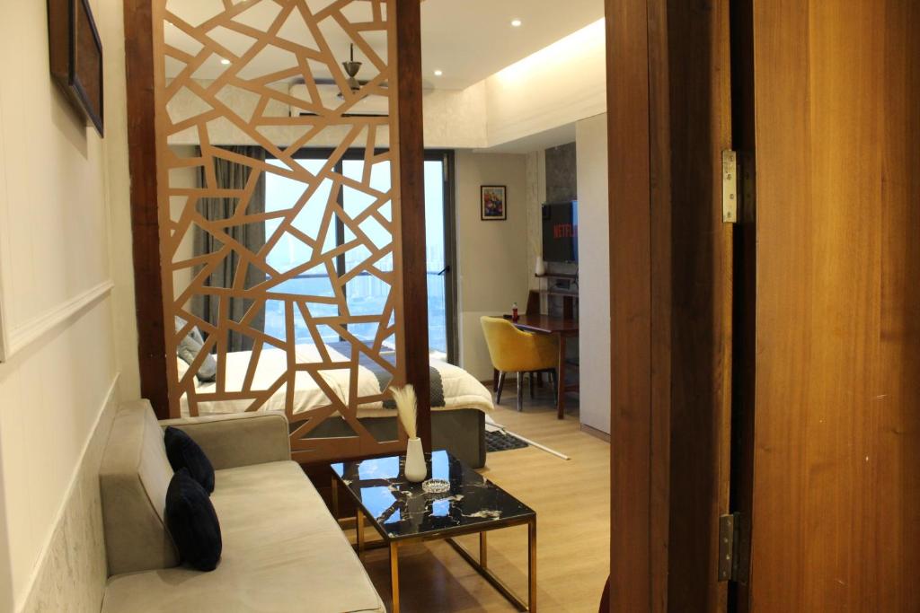 a living room with a spiral staircase in a room at Pillowtalks Cloudnine Stays in Ghaziabad