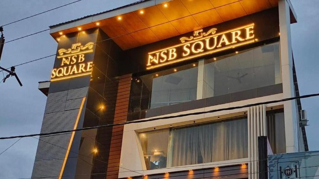 a building with a sign that reads nest square at Hotel nsb square in Dehradun