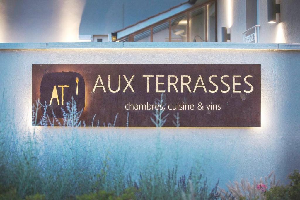 a sign on a wall that reads at aux ferrispaces at Hotel Aux Terrasses in Tournus