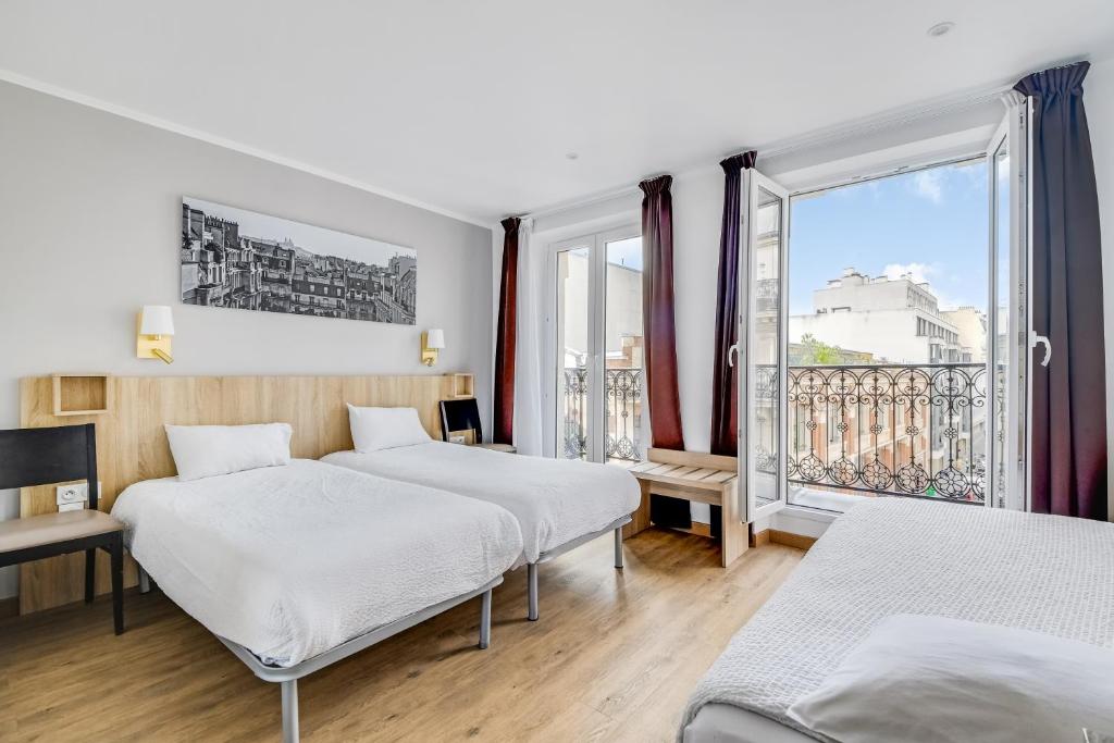 a hotel room with two beds and a window at Altona in Paris