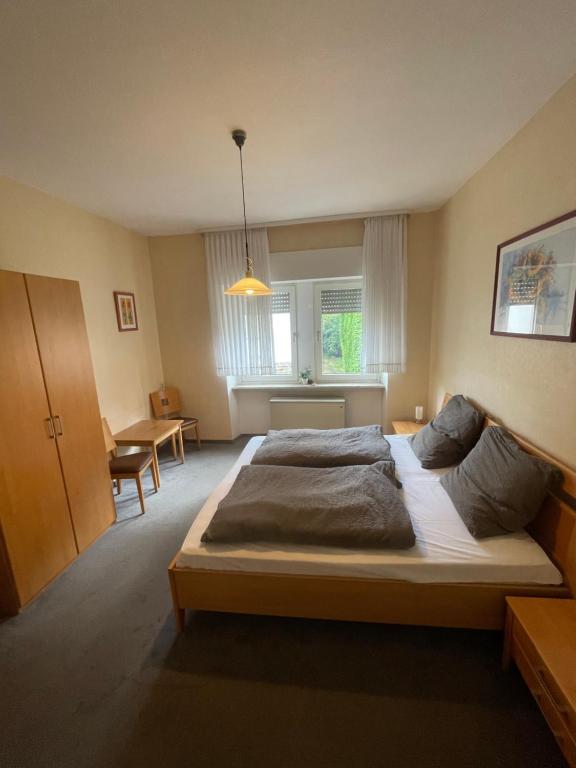 a bedroom with a large bed in a room at Zimmer Mosella in Enkirch