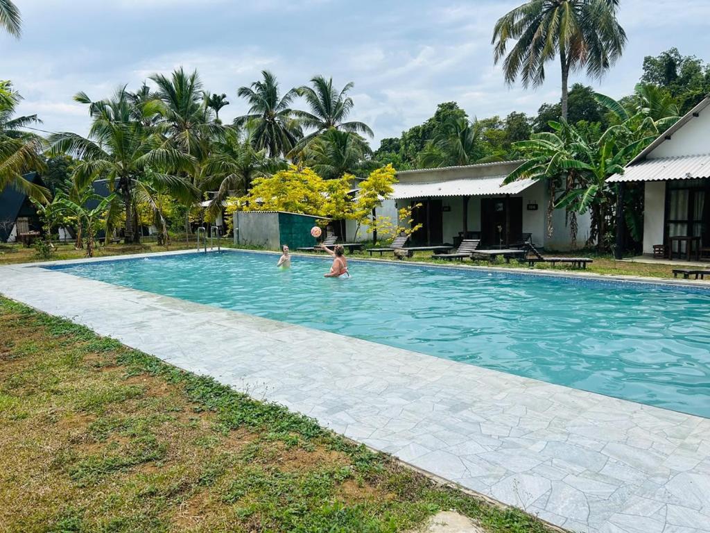 two children playing in a swimming pool at Hotel Mandara Udawalawe in Udawalawe
