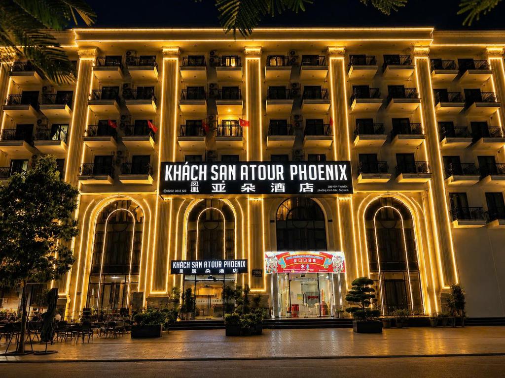 a large building with a sign in front of it at ATOUR Phoenix Hotel in Bắc Ninh
