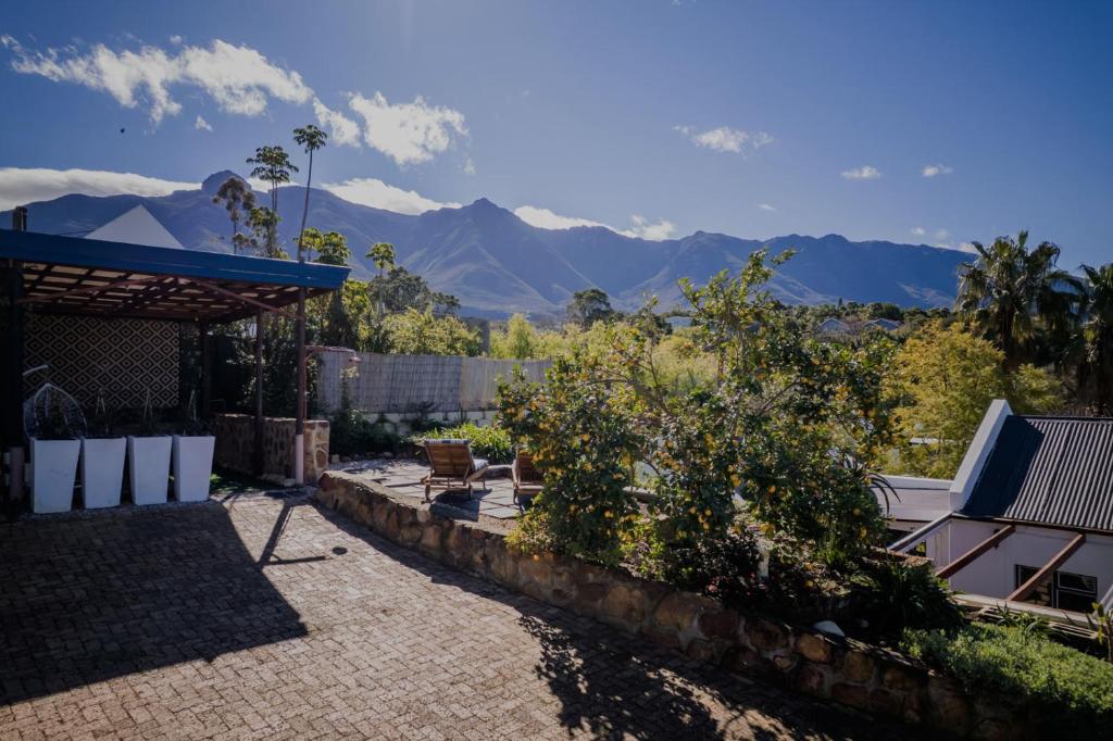 a view of mountains from the backyard of a house at Serenity Cottage in Swellendam