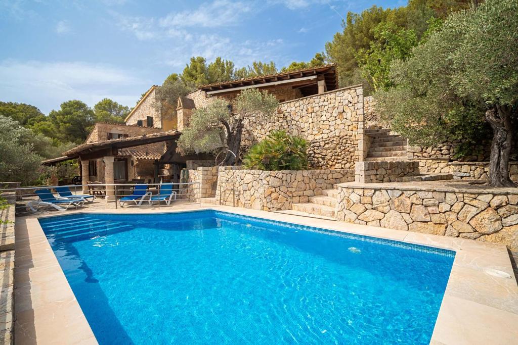 a swimming pool in front of a house at Can Xilla by Sealand Villas in Alcudia