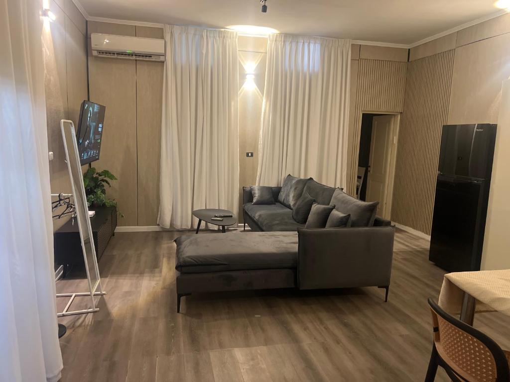 a living room with a couch and a television at בית הקונגרס גבעת אולגה in H̱adera