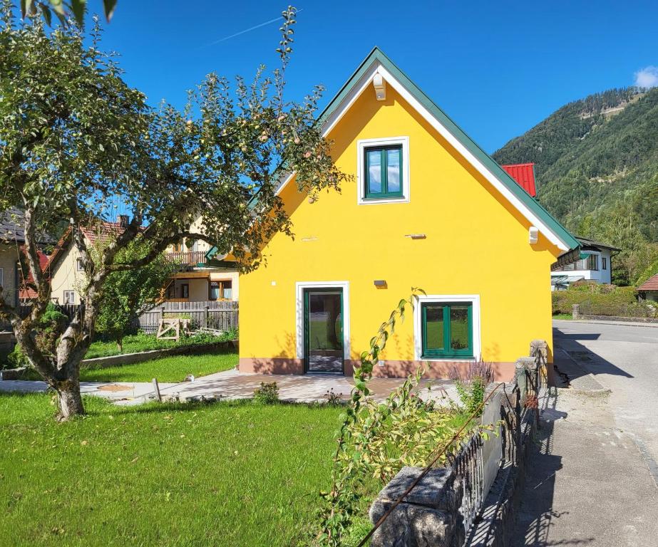 a yellow house with a fence in front of it at Ferienhaus Vitabene in Hollenstein an der Ybbs