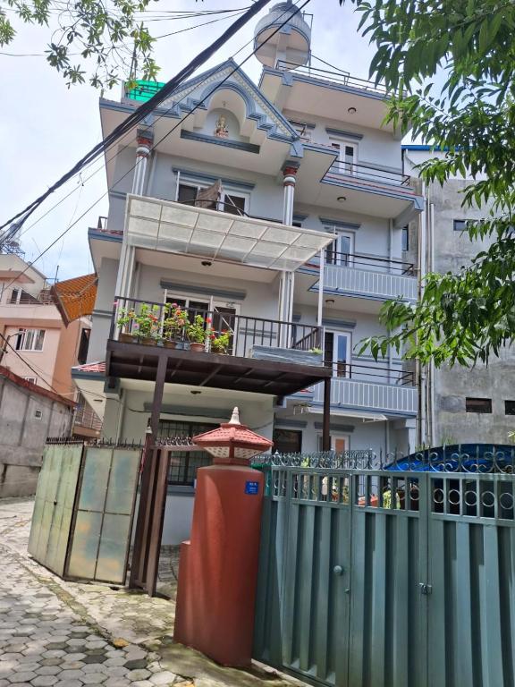 a building with a fence in front of it at Aangan Homestay in Pātan
