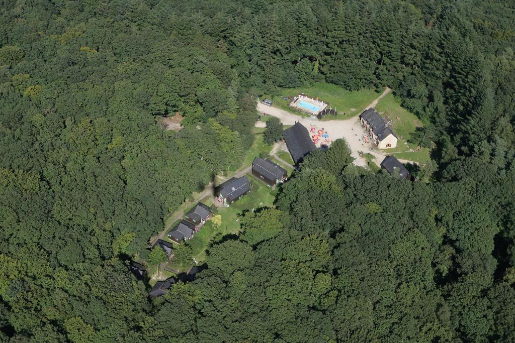 an aerial view of a house in the middle of a forest at Gite de la Croix du Hêtre in Hambers