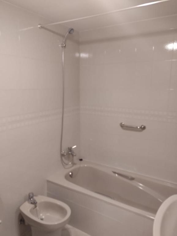 a bathroom with a tub and a toilet and a sink at Eclipse in Olvega