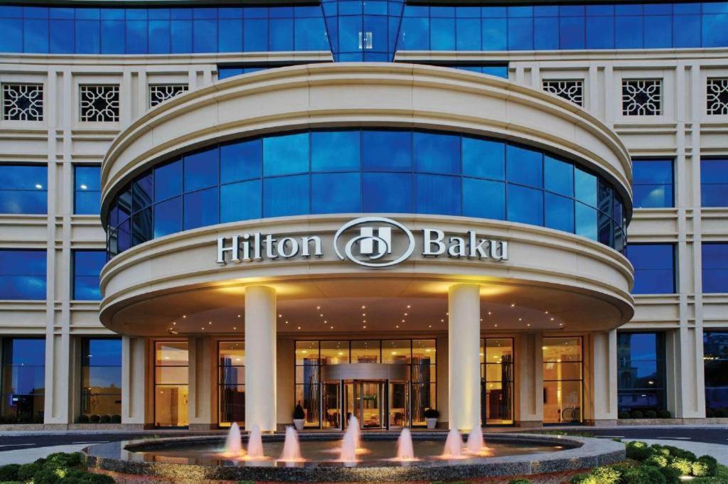 a building with the hilton bali sign on it at HILTON Residence of LUXURY 5 STARS apartment F1 in Baku