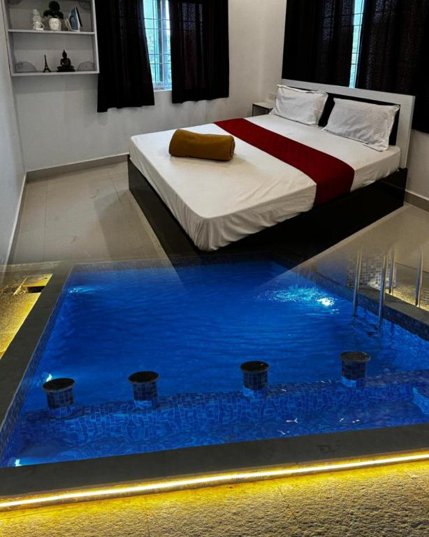 a bedroom with a bed and a pool of water at Dreamy beach villa in Pondicherry