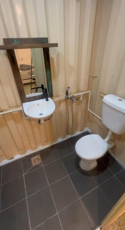 a bathroom with a toilet and a sink at Beach hut cabin in Marang