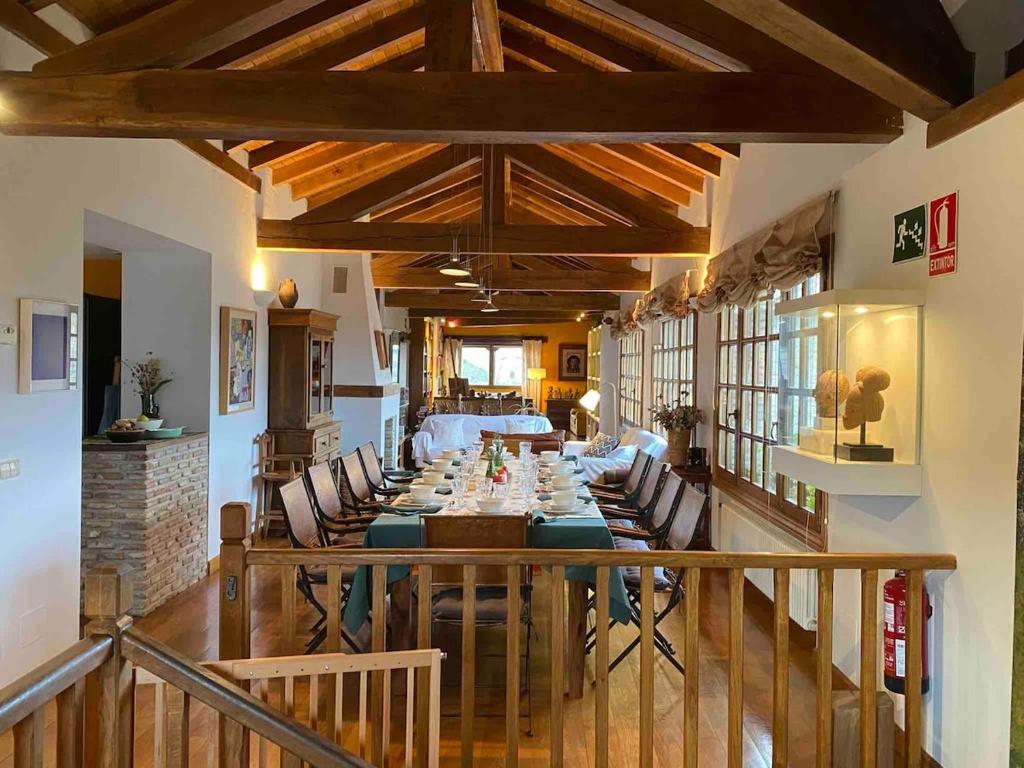 a dining room with a long table and chairs at Etxauri Palace for art lovers in Echauri