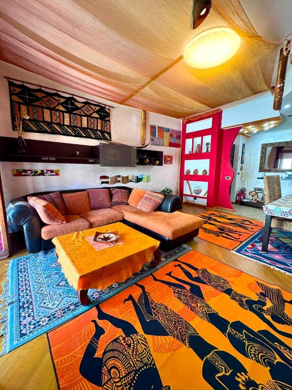 a living room with a couch and a rug at Casa Etnica in Latina