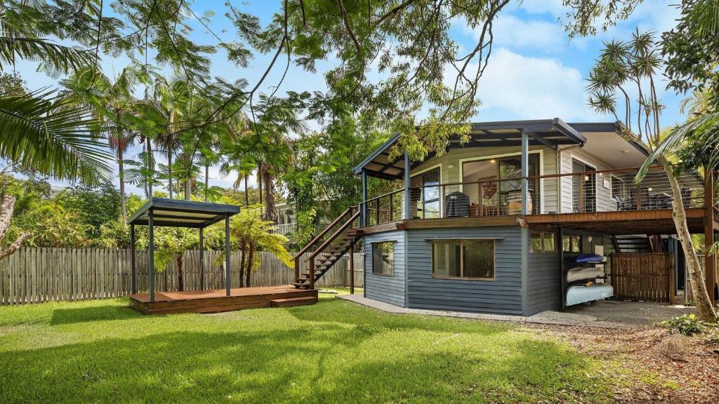 a house with a large yard with a deck at L'Aqua by Lifestyle. in New Brighton