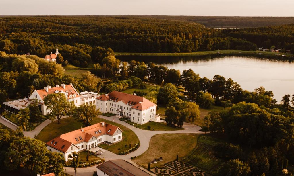 an aerial view of a house with a lake at Herbarium Hotel & Spa in Gąsawa