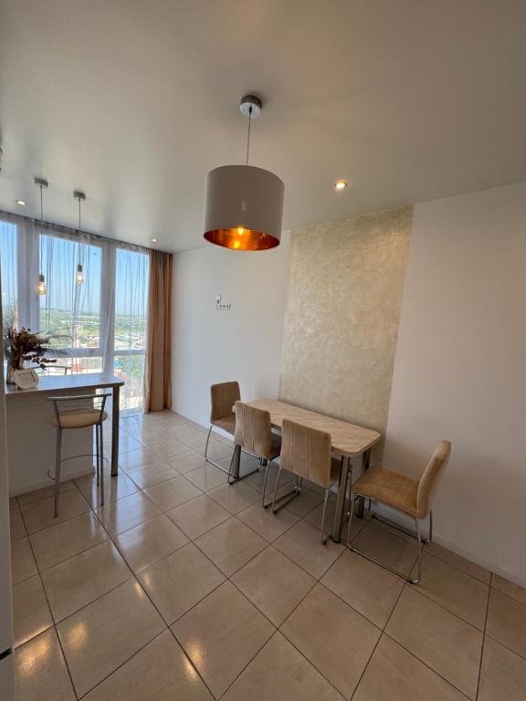 a dining room with a table and chairs at Panorama Apartment in Lviv