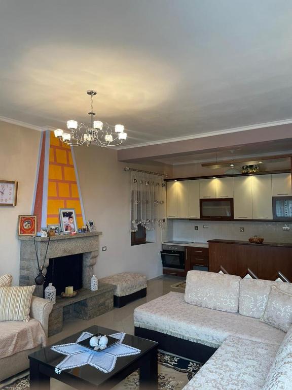 a living room with a couch and a fireplace at Stone House Leskovik in Leskovik