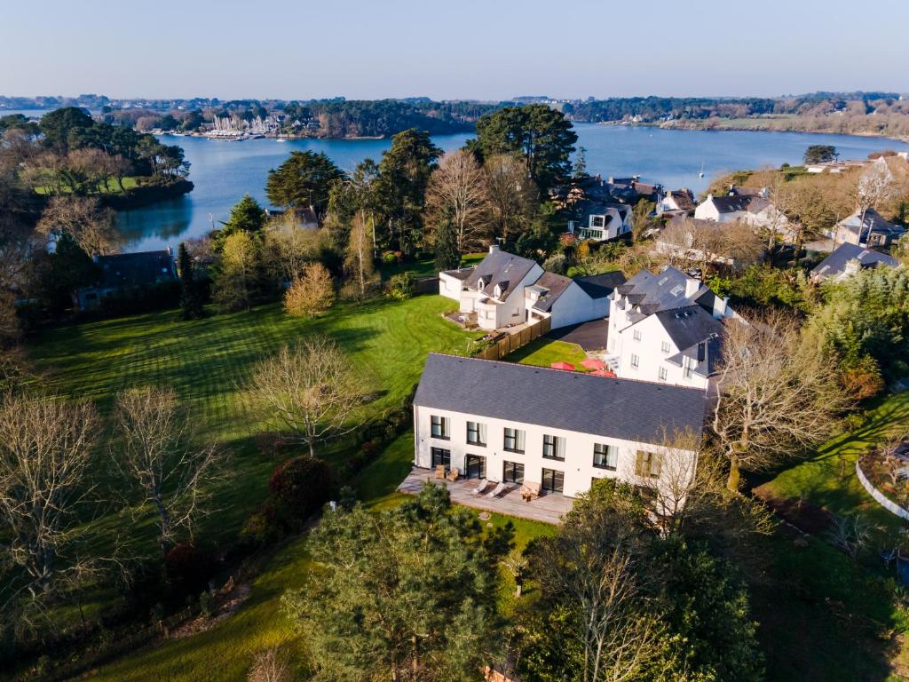 an aerial view of a house with a lake at MH Hôtel & Spa Arradon - Golfe du Morbihan in Arradon