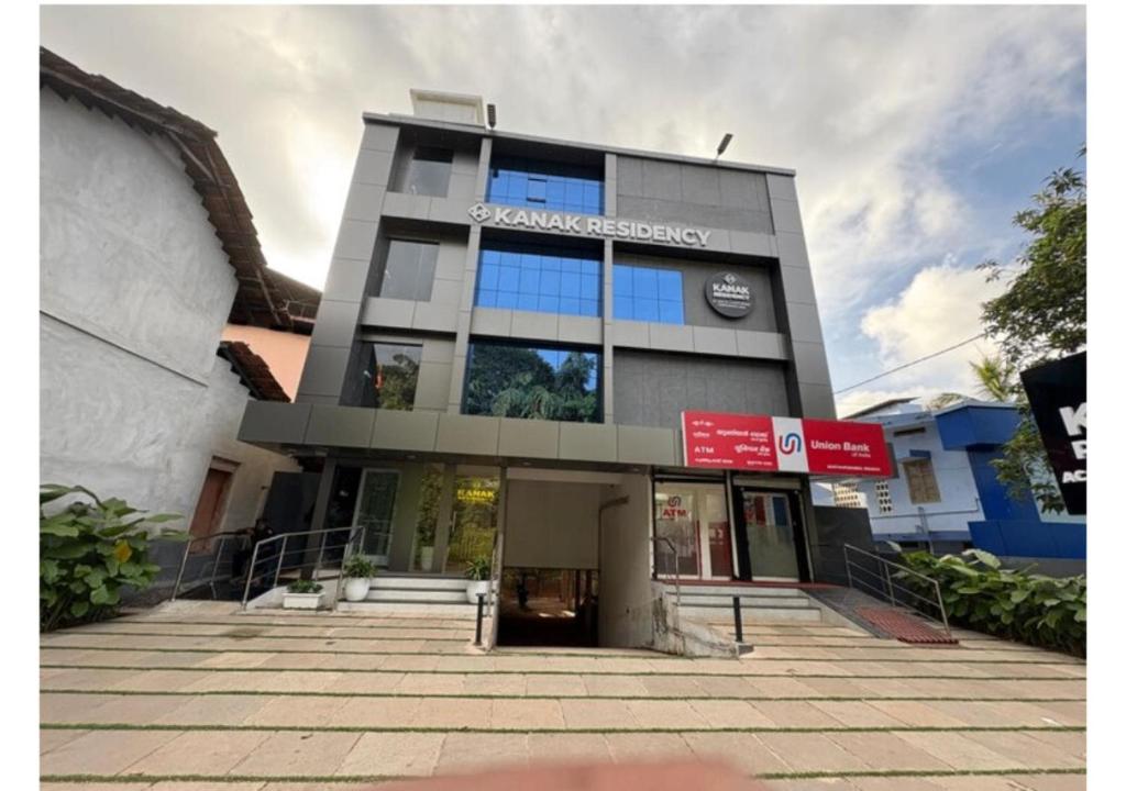 a building with a sign on the front of it at Kanak Residency Kuthuparamba in Kottayam