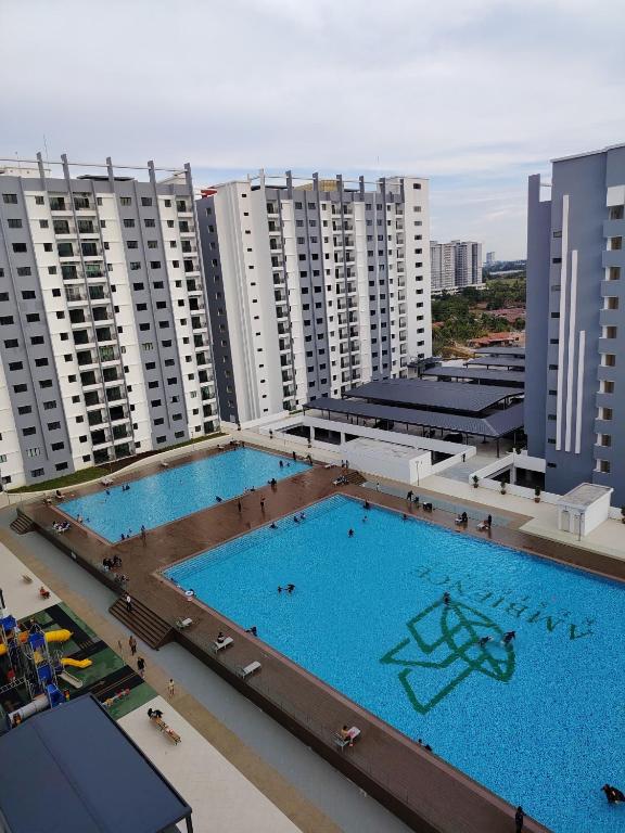 an overhead view of two swimming pools on a building at Riverfront Homestay at Ambience Residence in Malacca