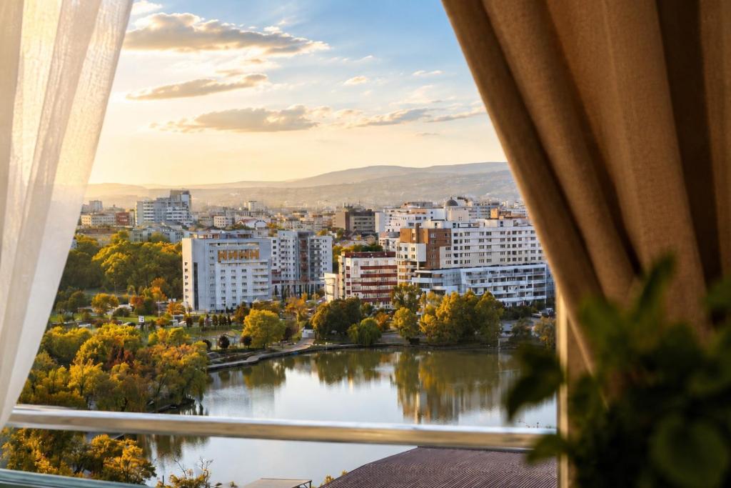 a view of a city from a window at Red Hotel Accommodation in Cluj-Napoca