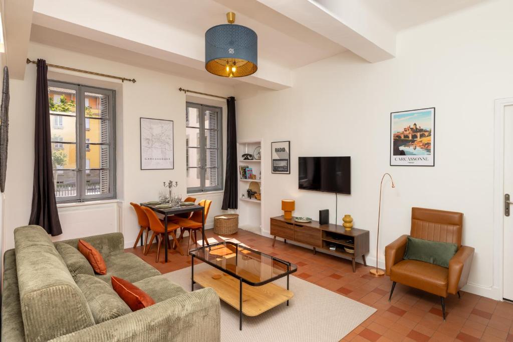 a living room with a couch and a table at T2 Design Centre Cité 10 min in Carcassonne
