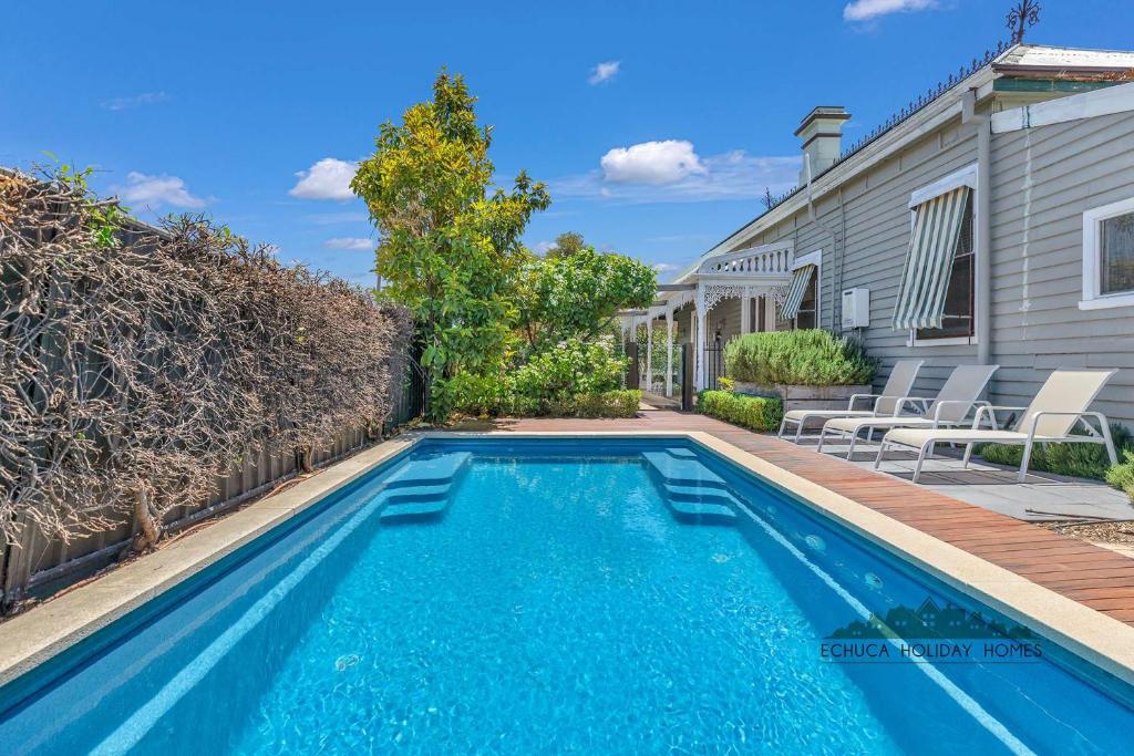 a swimming pool in the backyard of a house at Central Charm in Echuca