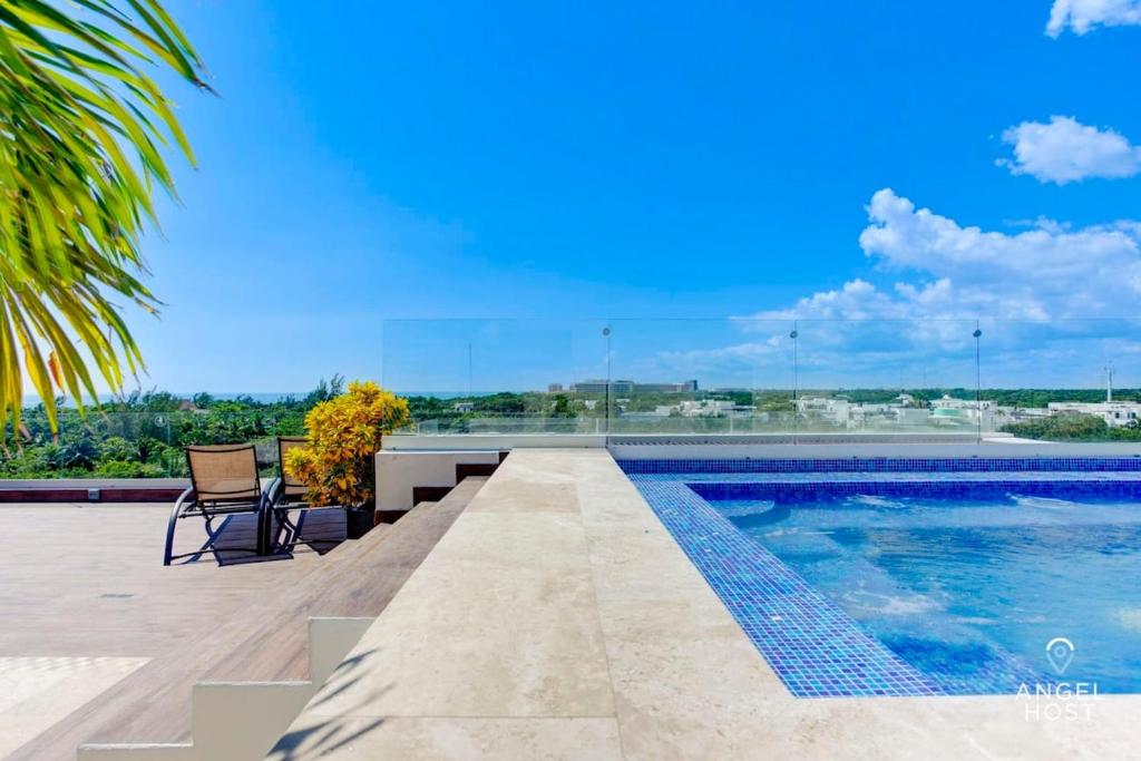 a swimming pool with a table and chairs on a patio at Eight Condos Multi Listing in Playa del Carmen