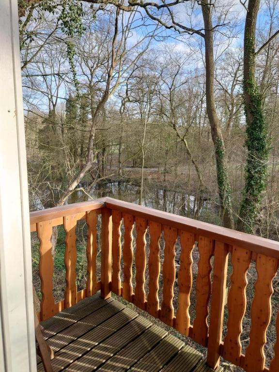 a balcony with a view of a river and trees at House at Jenischpark in Hamburg