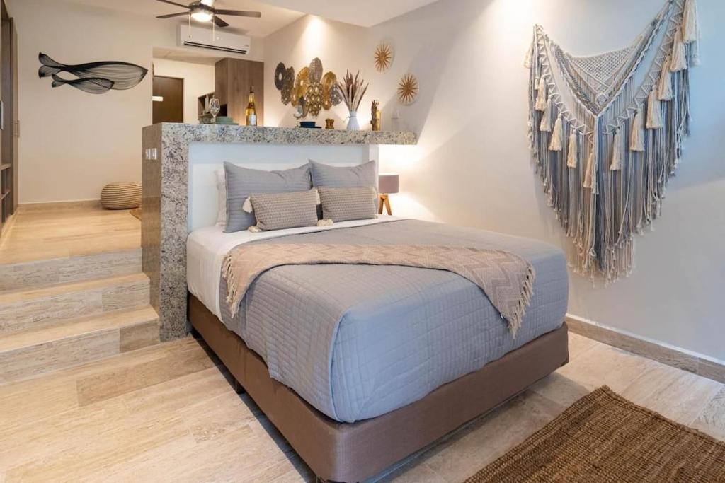 a bedroom with a king sized bed in a room at Syrena Multi Listing in Playa del Carmen