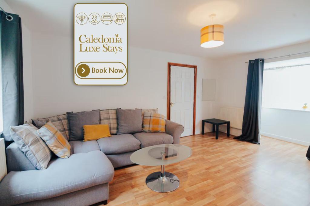 a living room with a couch and a table at The Coastal Breeze in Porthmadog