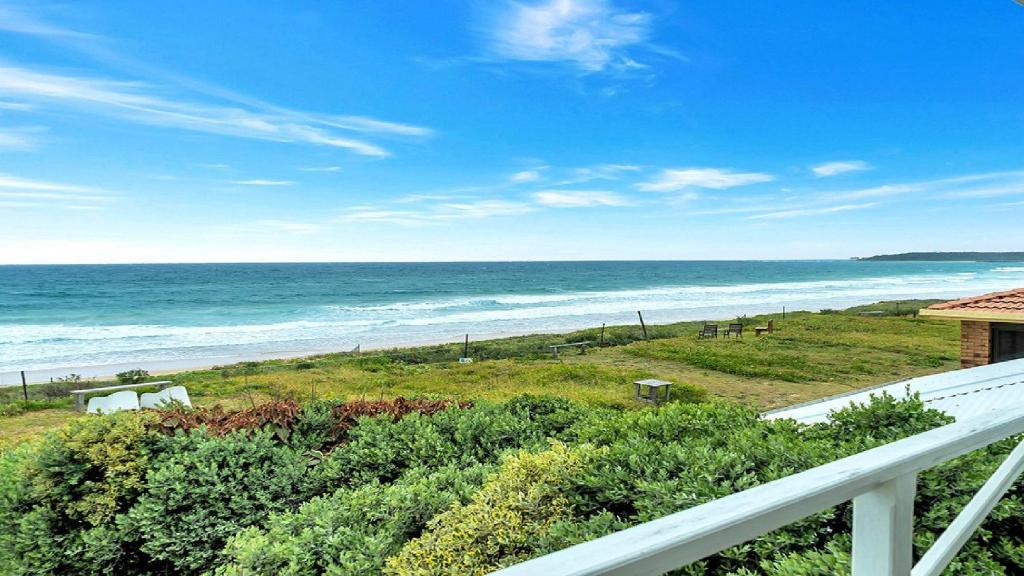 a view of the ocean from the balcony of a house at On The Beach in Wooli