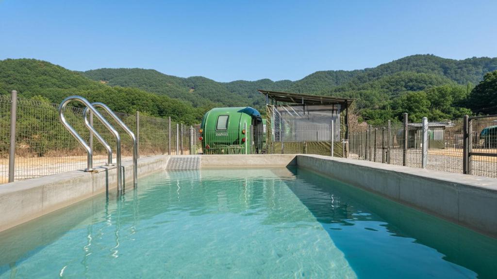 a pool of water with a playground in the background at Yangyang Lira Camp in Yangyang