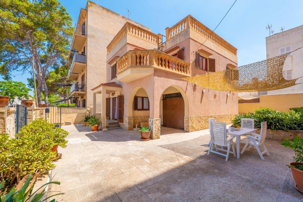 a patio with a table and chairs in front of a building at Can Pedro Ros in S'Illot