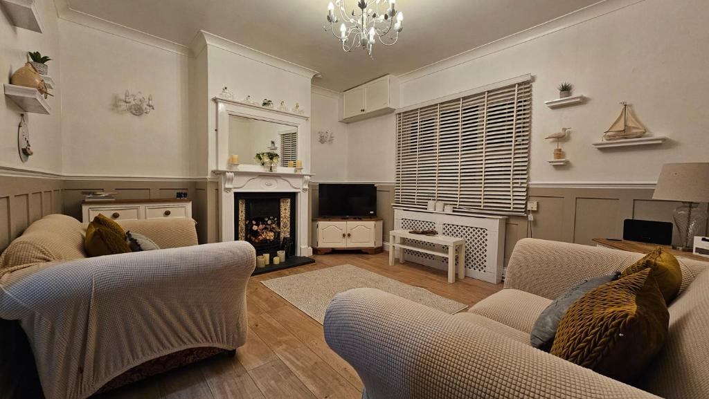 a living room with two couches and a fireplace at Twisted Chimney View in Alford