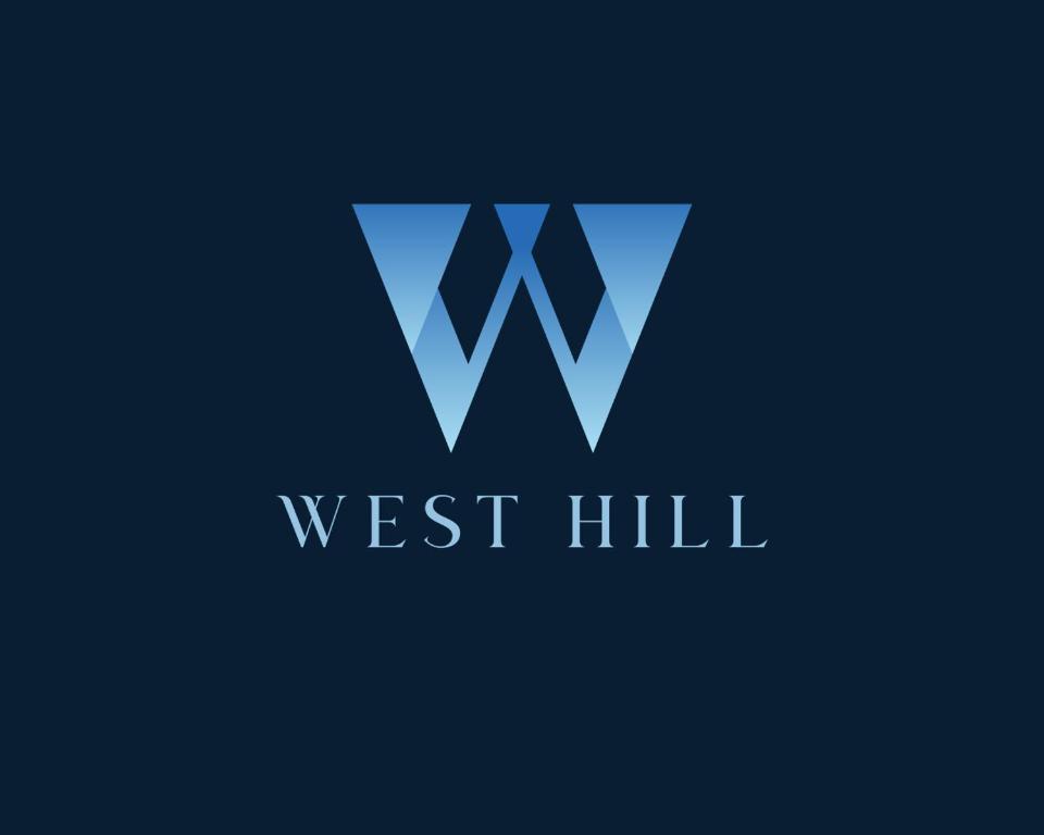a blue w logo on a black background at West Hill Apart Hotel in Kopaonik