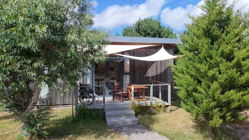 a house with a porch with a table and chairs at The Gallery Lodges in Braunton