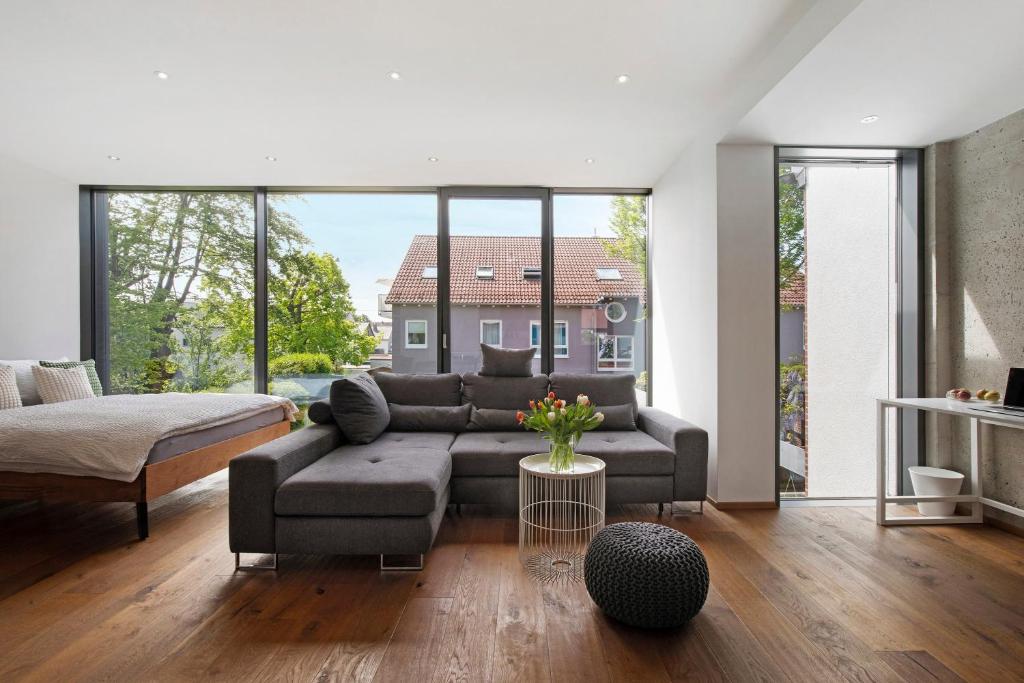 a living room with a couch and a large window at Studio-Wohnung Lichtblick in Gersthofen