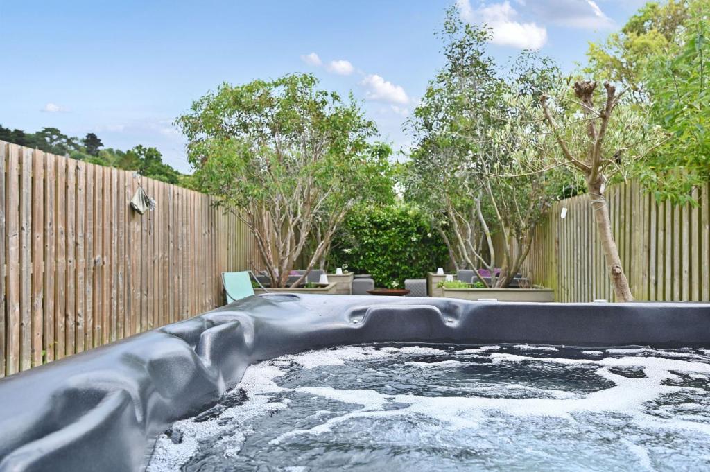 a water slide in a backyard with a fence at Hydrangea House in Hythe