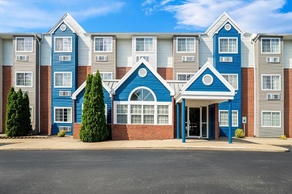 a large building with blue and white at Microtel Inn Georgetown - Lexington North in Georgetown