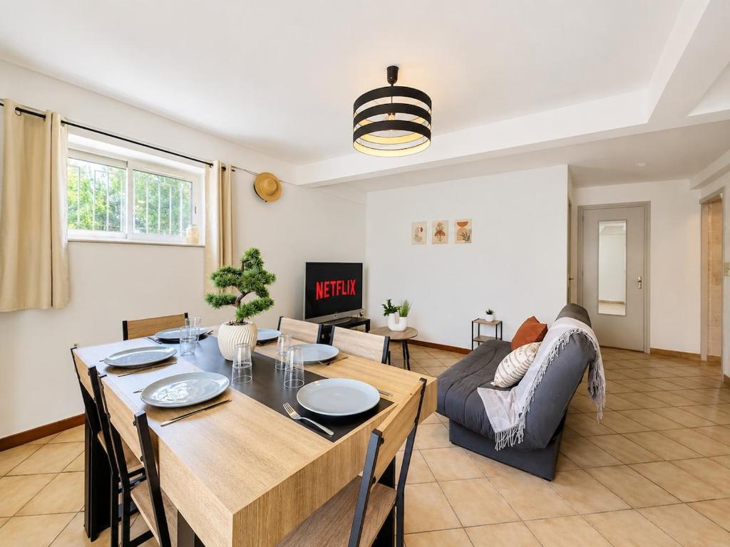 a living room with a table and a couch at Le logis de Louze in Saint-Maurice-lʼExil