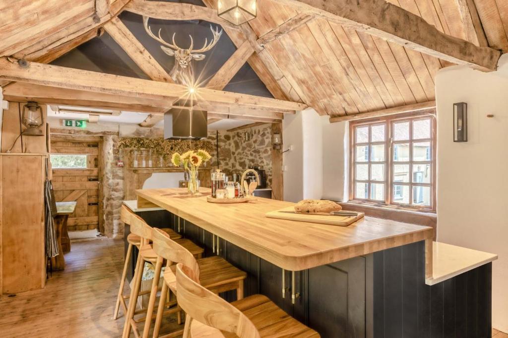 a kitchen with wooden ceilings and a large island at 5 Bed in Bishops Lydeard oc-b45427 in  Liscombe