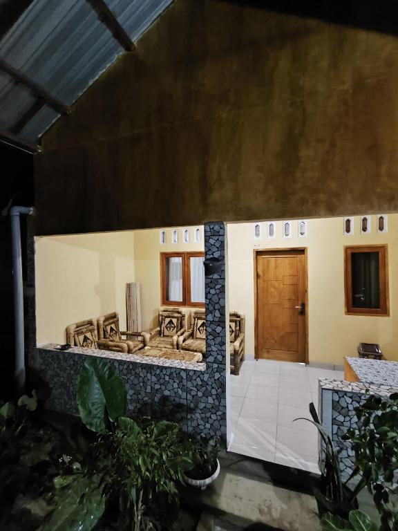 a model of a house with a wooden door at Tetebatu Clove Garden in Tetebatu