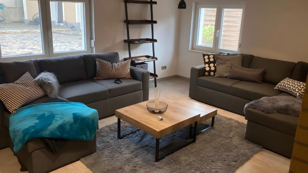 a living room with two couches and a coffee table at Ferienwohnung Für 4 Personen 90 M² in Naumburg