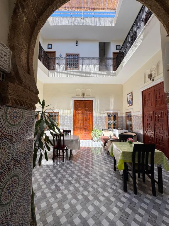 an archway in a living room with a table and chairs at Riad Ba brahim in Rabat