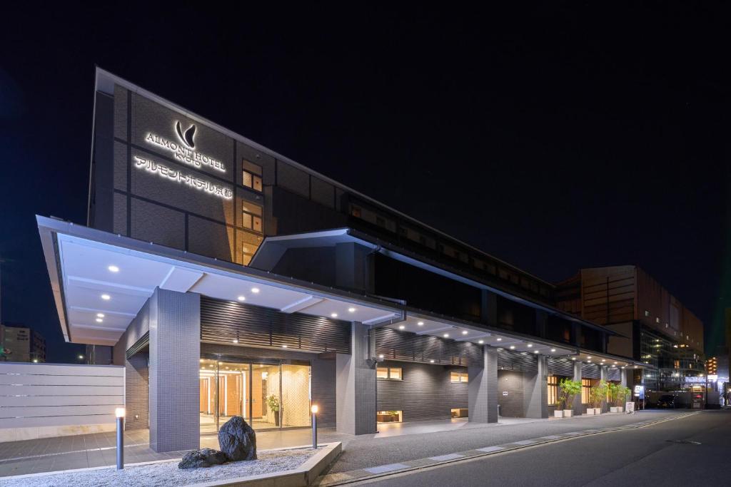 a large building with lights on it at night at Almont Hotel Kyoto in Kyoto